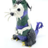 A strange looking squirrel creature with three eyes.